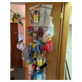 Wire racks, shower curtain rods, duster, Scentsy cubes and other cleaning supplies on door