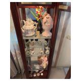 Contents of clock shelves includes Avon egg shaped pink music box, shoes, doll, etc