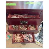 Contents of jewelry armoire includes necklaces, bracelets, earrings and more