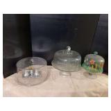 Two glass cake stands w covers, plastic covered platter and S&P shakers w toothpick holder and tray