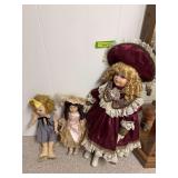 Three collector dolls, one hard plastic and two bisque with cloth bodies