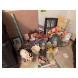 Corner of goodies includes picture frames, piggy bank, wall art, paper flower bouquet, mini shoes and more