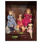 Bisque collector dolls with cloth bodies of all sizes, squeaky rubber sheep and cloth Betty Boop Two tall dolls are Marie Osmond dolls