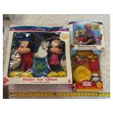 Three new in package, Mickey Mouse toys, float and fun gift set, stamp and squirt friend, and musical roly-poly