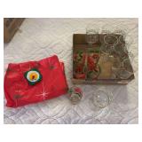 5 poinsettia water glasses, 8 holly wine glasses and plastic tablecloth
