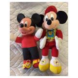 Two stuffed Mickey figures one marching band director