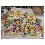 Large assortment of Mickey Mouse books, puzzles, and paper goods
