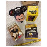 Mickey Mouse bobble head new in box, Mickey Mouse lunch kit, Sesame Street record and film strip and Mickey Mouse popcorn tin