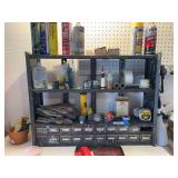 Tool organizer shelf includes assortment bin with some hardware plus tape measures, gloves, laser level, chalk line
