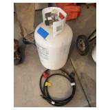 Oversized propane tank with hoses - full