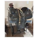 Maker mark worn - ??? Laredo Texas saddlery decorative tooled saddle with the stand, includes braided rawhide reins and rein spreader plus spurs