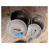 Two unmarked cast-iron Dutch ovens