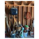 Garage wall contents-charcoal grill, drop cords, jumper cables, bench, basket, planter and probably more