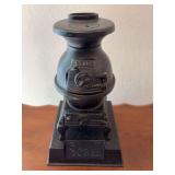 Sears mini cast iron pot belly stove, probably display item 10" tall on a base marked Sears