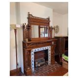 Magnificent fireplace mantle 60" wide x 88" tall. Ornately carved panels, stick and ball spindles, beveled edge mirror. A wonderful piece to reinstall in your home! This was built in as an artificial 