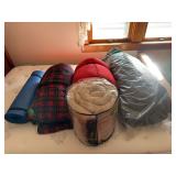 Four sleeping bags and a sleeping pad