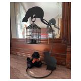 Small decorative bird cage with cats waiting for their lunch and a Boyd’s black cat