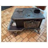 Unmarked cast iron mini cookstove 13"+ wide x 8" tall, hinges on front door are broken