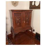 Double door cabinet w/ carved cherub on doors and legs 18D x 34L x 56H