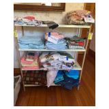 On shelf includes decorative pillows, bath towels, holiday, hand towels, fancy work doilies, etc