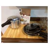 Pressure cooker, set of skillets, cherry pitter, and assorted canning supplies