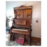 Walnut Eastlake style pump organ with spoon carved back