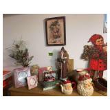 Various Christmas decor includes frames, figurines, art, etc