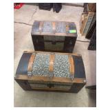 Two humpback trunks, handles on one and not the other