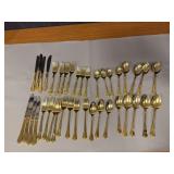 Two sets gold handled flatware for 4, short one fork