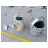 2 metal watering cans and 3 wooden planter boxes