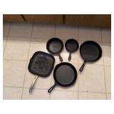 Four cast iron skillets, square griddle skillet