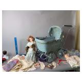 Wicker baby buggy with dolls and clothes