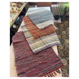 Four woven rugs