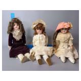 Three bisque dolls, two with sleep eyes