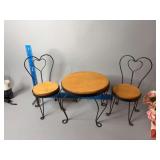 Doll size table with two chairs and two porcelain dolls, set up for tea