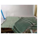 Two green woven rugs, 26” x 46”