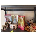A shelf of Barbies and other fashion dolls
