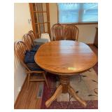 52x42 oak dining table with (2) 18” leaves and 7 chairs Some chairs do have loose backs