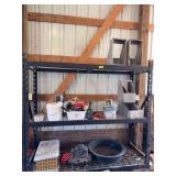 On shelves includes tools, small Lasko heater, animal carrier, air compressor, etc