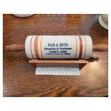 Stoneware rolling pin with advertising and rest “Ellis A Betts Groceries & Hardware Casey, Iowa A Good Place To Trade”