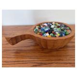 Wooden bowl full of marbles
