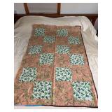 Machine stitched and custom quilted measures 42x63