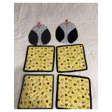 Four hot pads and a pair of oven mitts