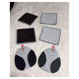 Four hot pads and a pair of oven mitts