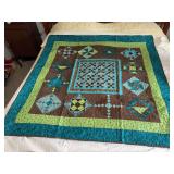 Machine stitched and custom quilted measures 60x60