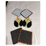Four hot pads and a pair of oven mitts