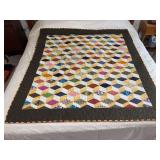 Machine stitched and custom quilted measures 64x59