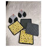 Four hot pads and a pair of oven mitts