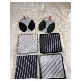 Four hot pads and a pair of oven mitts