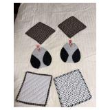 Four hot pads and a pair of oven mitts